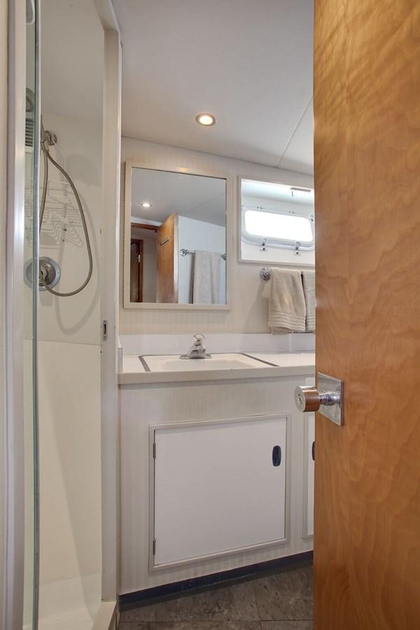 a bathroom with a sink and mirror aboard ALEXIS Yacht for Sale