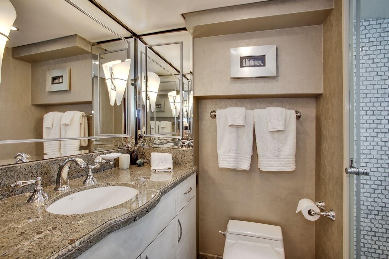 a bathroom with a countertop sink and mirror aboard ALEXIS Yacht for Sale