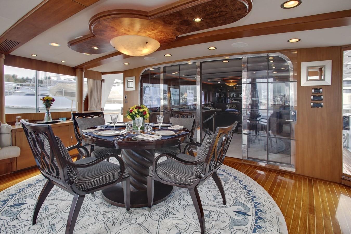 a room with a table chairs and a large window aboard ALEXIS Yacht for Sale
