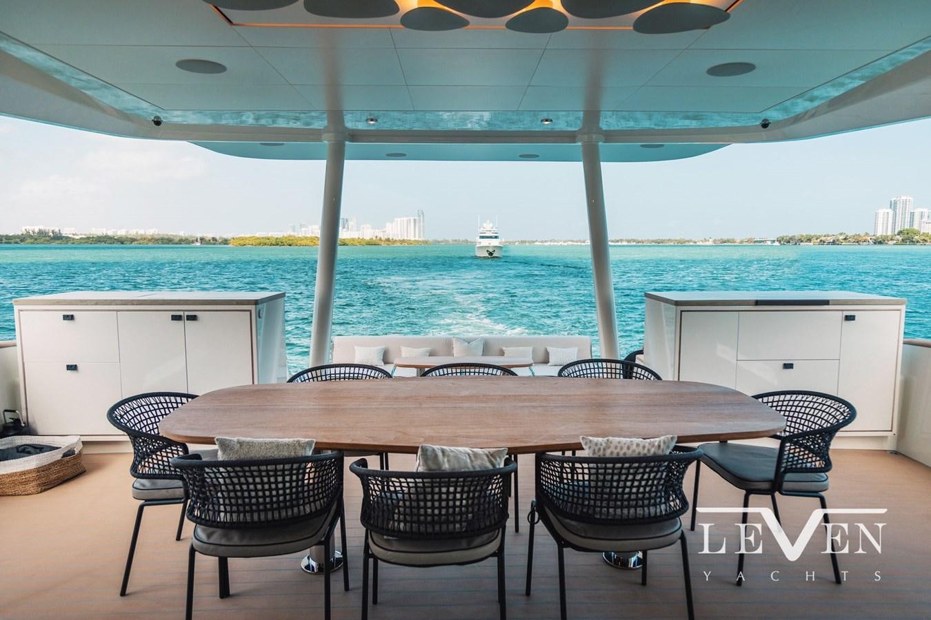 a table and chairs under an umbrella aboard LEVEN 90 LV01 Yacht for Sale