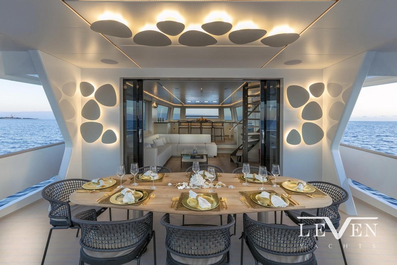 a dining table on a balcony aboard LEVEN 90 LV01 Yacht for Sale