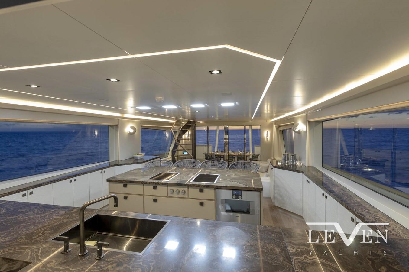 a large kitchen with a large window aboard LEVEN 90 LV01 Yacht for Sale