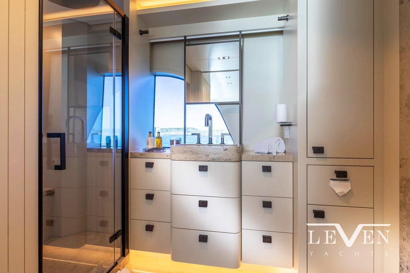 a bathroom with a large mirror aboard LEVEN 90 LV01 Yacht for Sale
