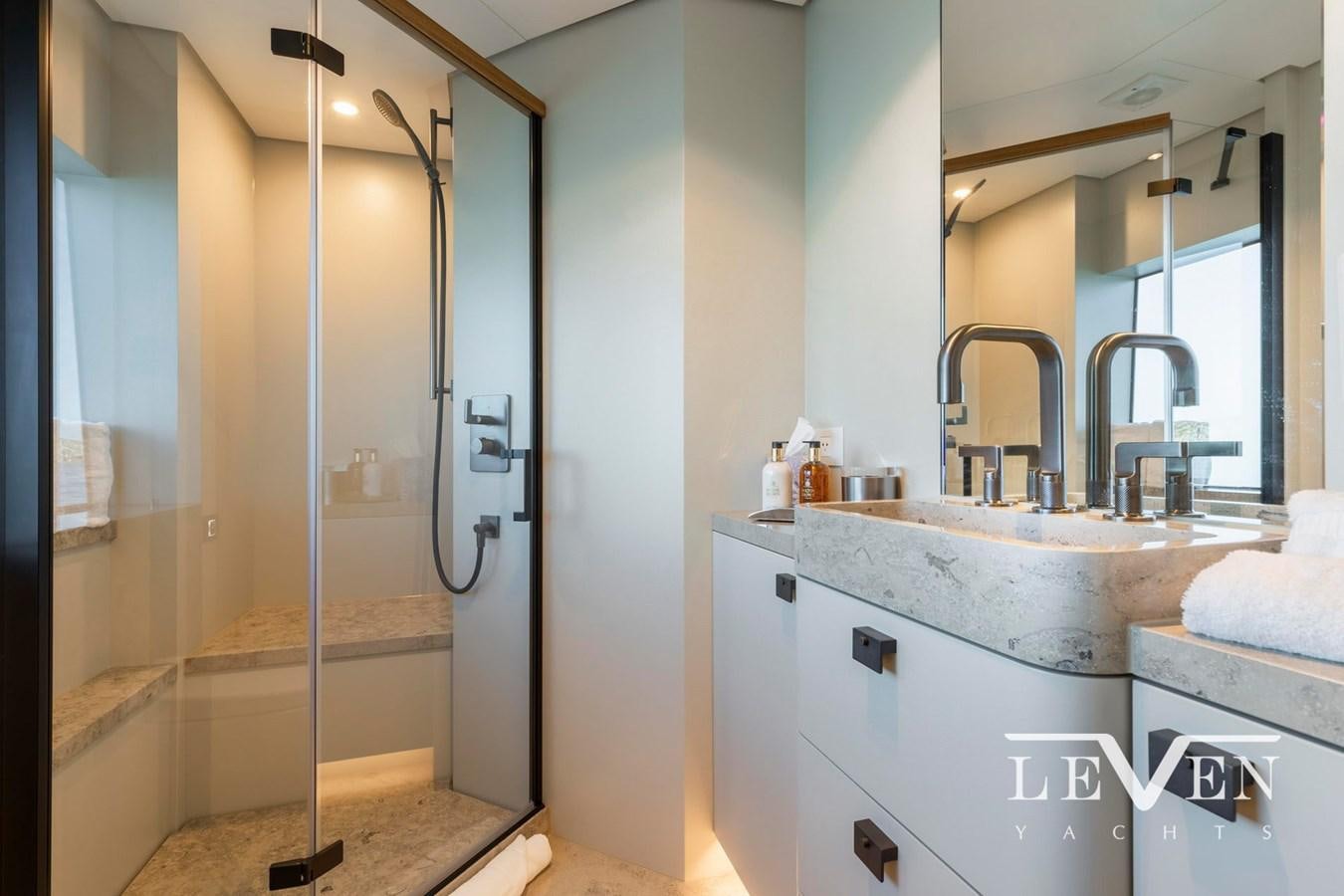 a bathroom with a glass shower aboard LEVEN 90 LV01 Yacht for Sale