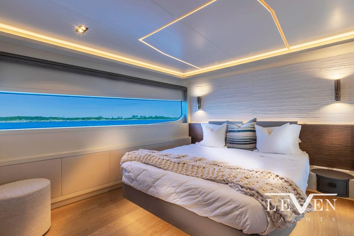 a room with a bed and a television aboard LEVEN 90 LV01 Yacht for Sale