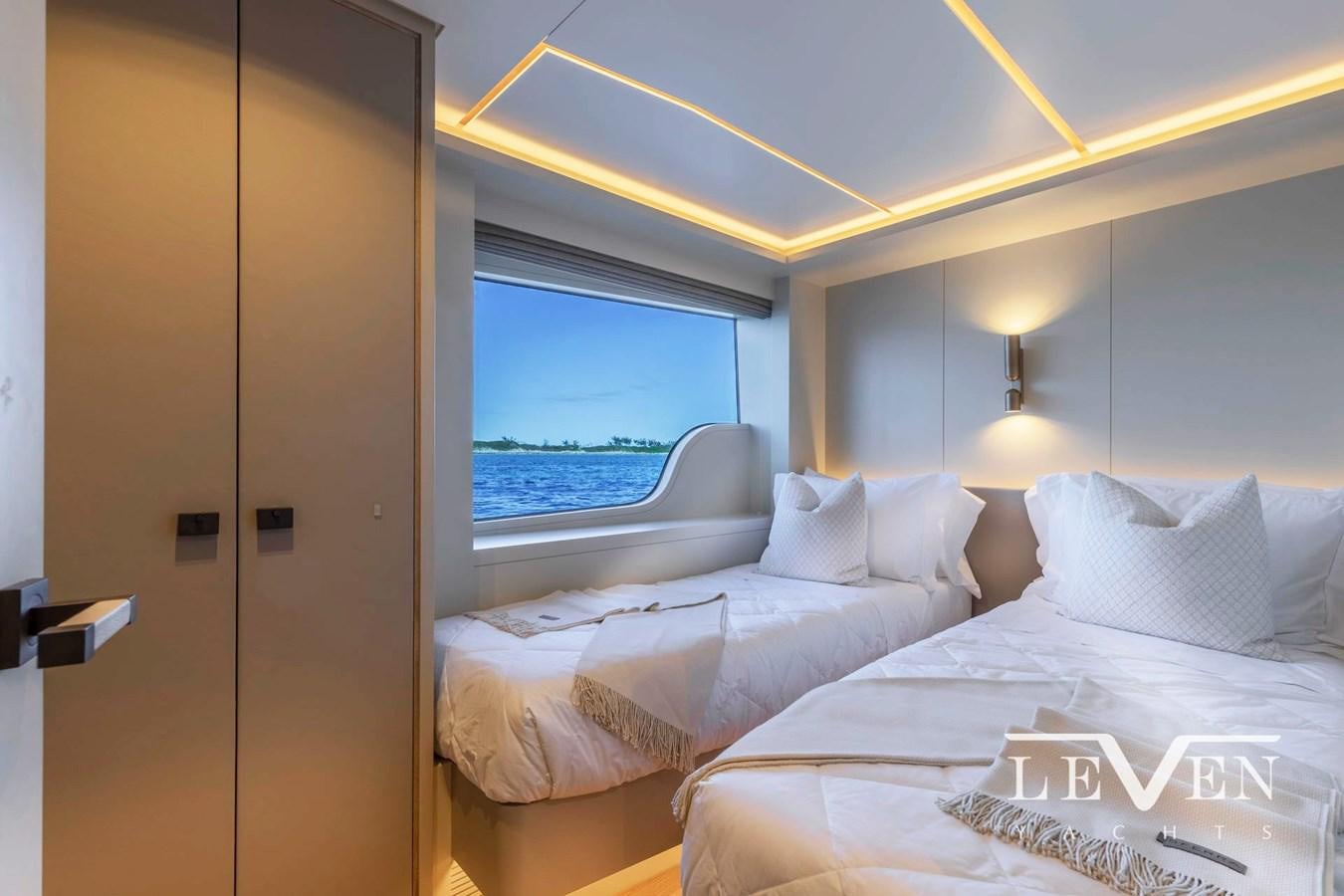 a room with beds and a window aboard LEVEN 90 LV01 Yacht for Sale