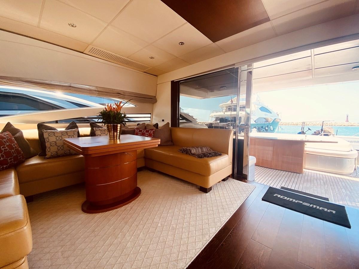 a living room with a large window aboard ROMPEMAR Yacht for Sale