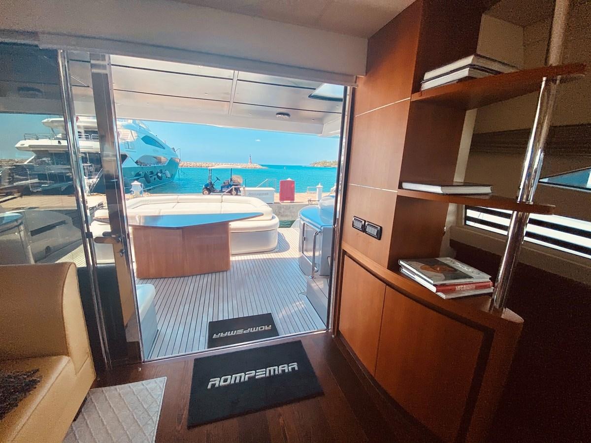 a room with a pool and a glass door aboard ROMPEMAR Yacht for Sale