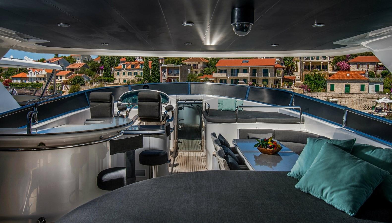 a room with a table chairs and a bed on a balcony aboard CONTE ALBERTI Yacht for Sale