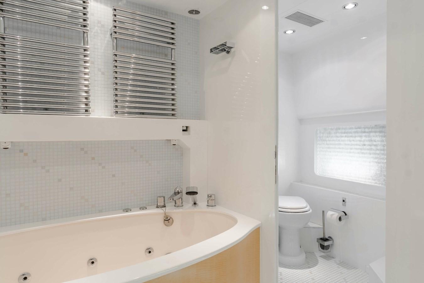 a bathroom with a tub sink and toilet aboard CONTE ALBERTI Yacht for Sale