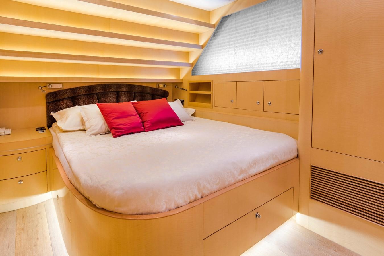 a bed with red pillows aboard CONTE ALBERTI Yacht for Sale