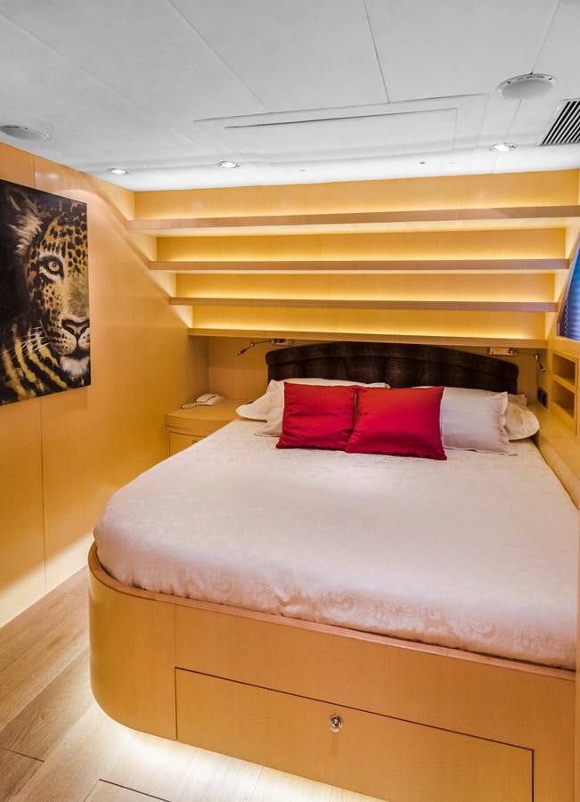 a bed with a red pillow aboard CONTE ALBERTI Yacht for Sale