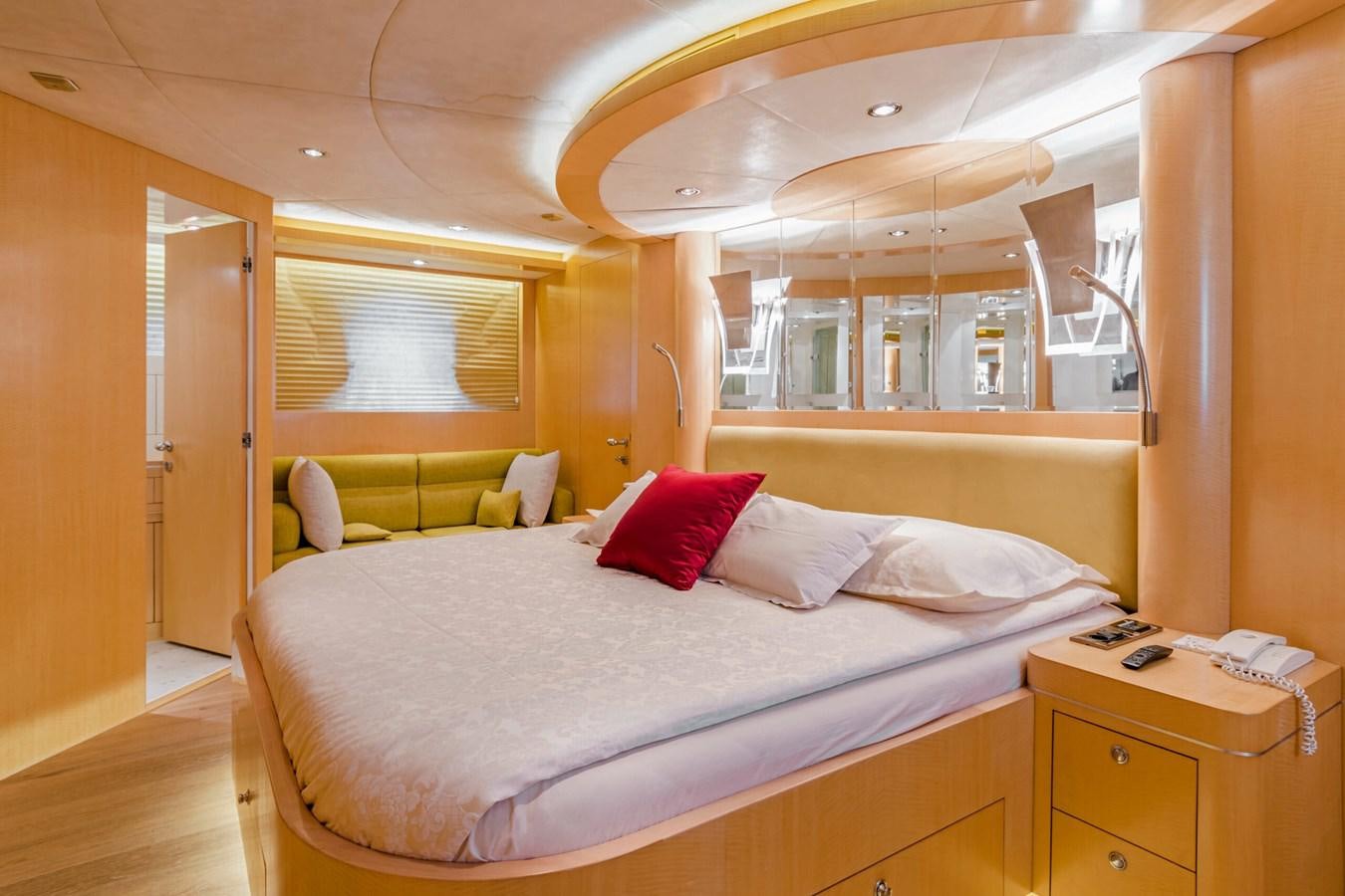 a bed with red pillows aboard CONTE ALBERTI Yacht for Sale