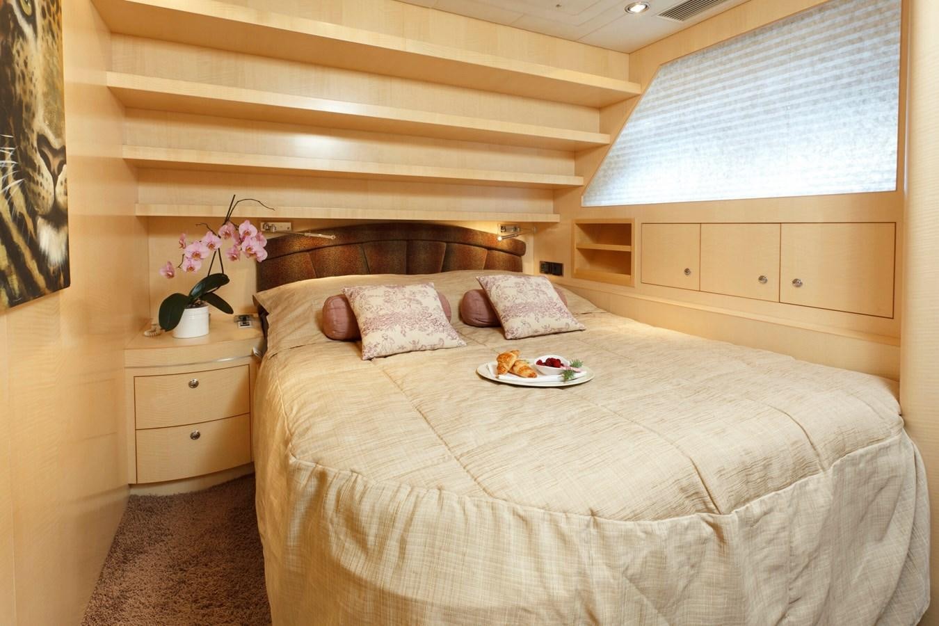 a bed with a tray of food aboard CONTE ALBERTI Yacht for Sale