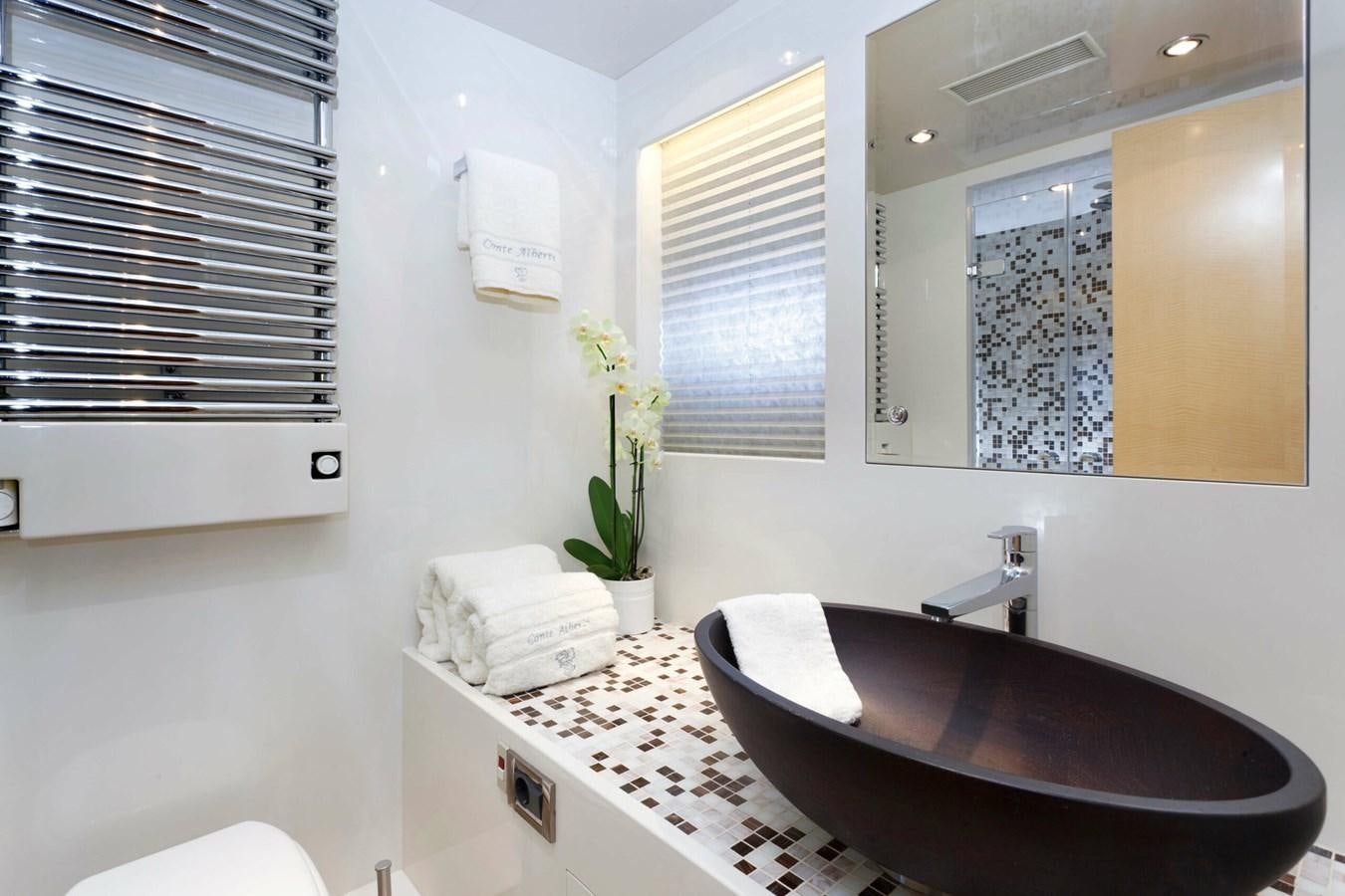 a bathroom with a sink and a mirror aboard CONTE ALBERTI Yacht for Sale