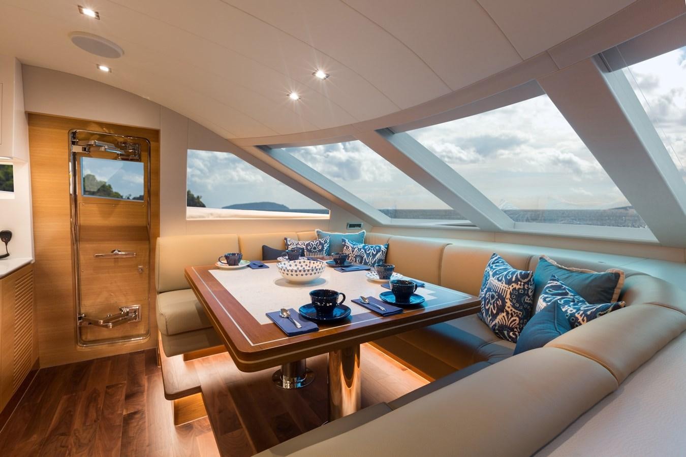 a room with a couch and a table with food on it aboard FD90  (NEW BOAT SPEC)  Yacht for Sale