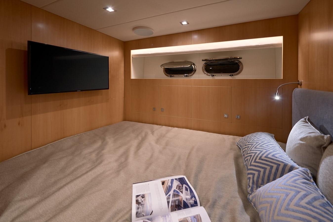 a bed with a television on the wall aboard FD90  (NEW BOAT SPEC)  Yacht for Sale