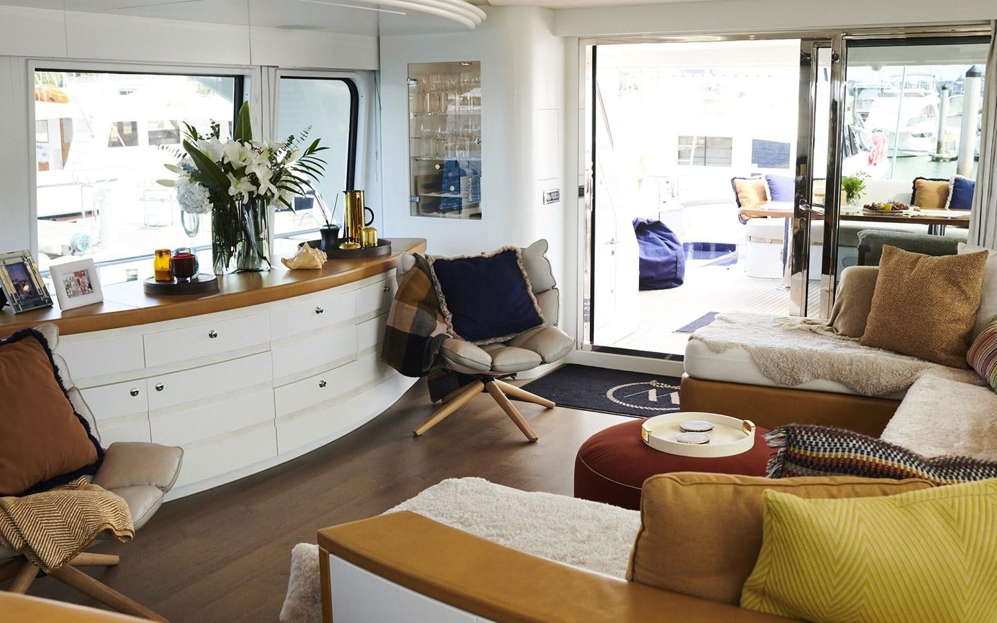 a living room with a kitchen and dining area aboard WILLOW Yacht for Sale