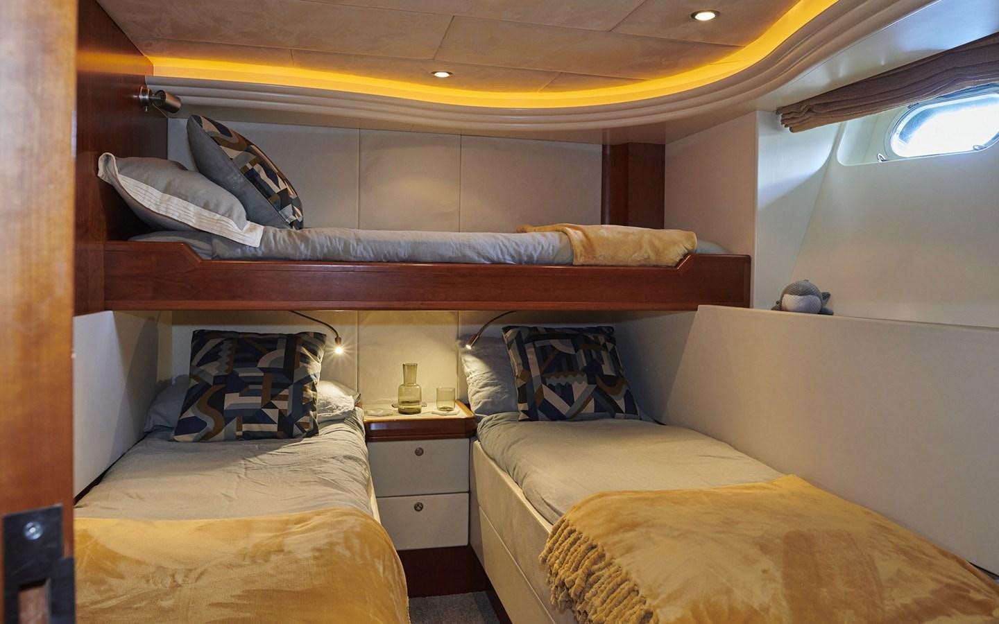 a room with beds and a dresser aboard WILLOW Yacht for Sale
