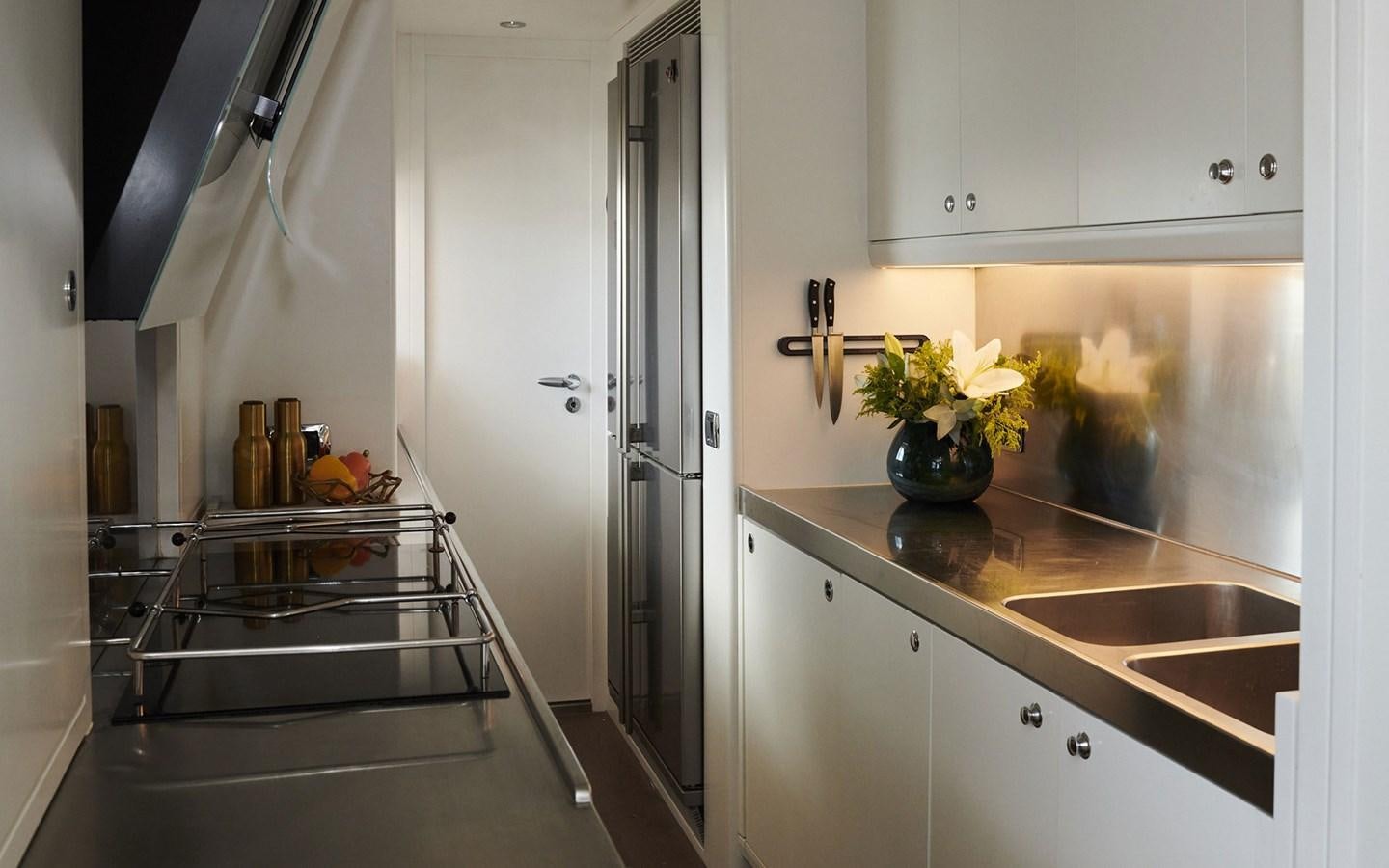 a kitchen with a glass table aboard WILLOW Yacht for Sale