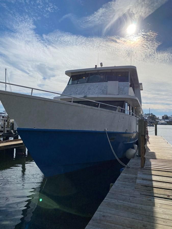 a boat docked at a pier aboard THE OASIS Yacht for Sale