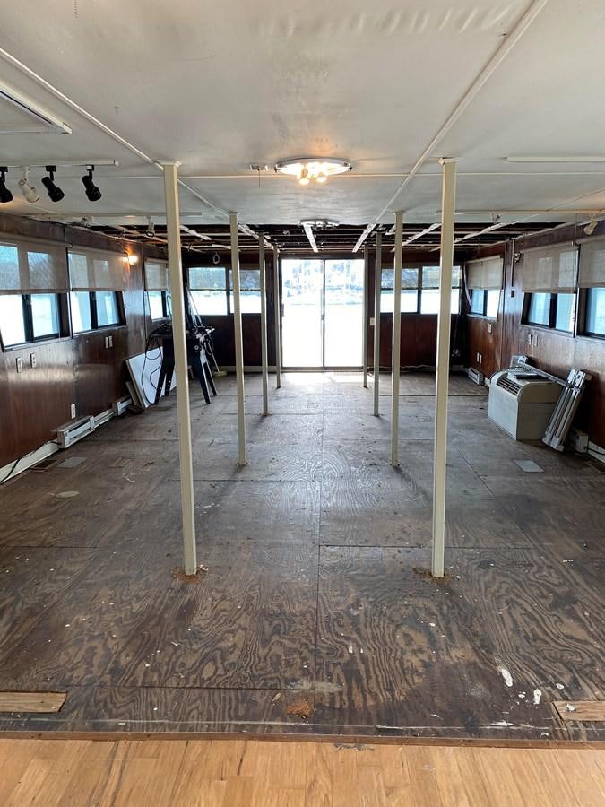 a room with a wood floor and a wood floor and a wood floor aboard THE OASIS Yacht for Sale