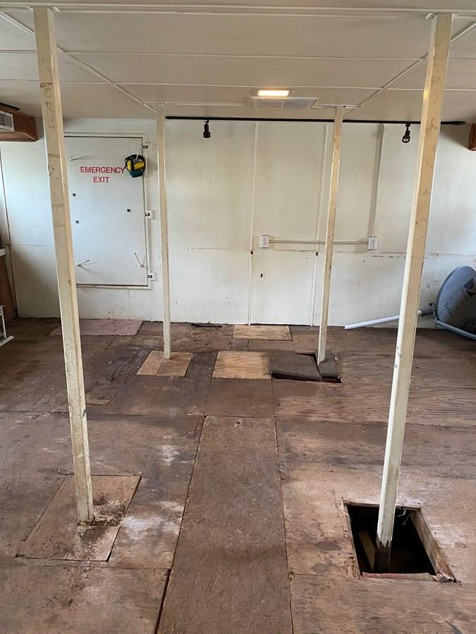 a room with a door and a ladder aboard THE OASIS Yacht for Sale