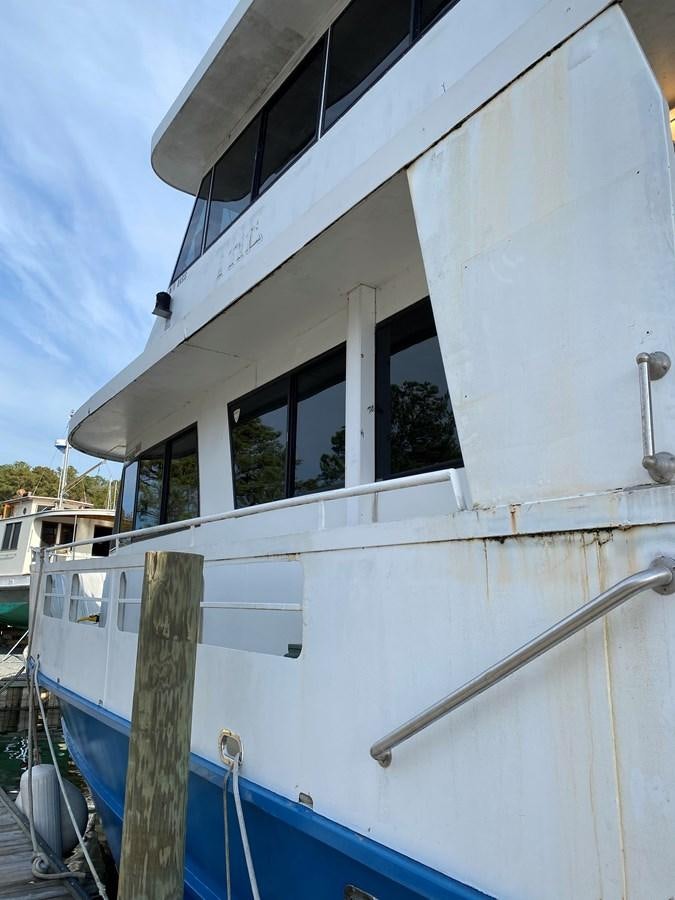 a white house with a blue roof aboard THE OASIS Yacht for Sale