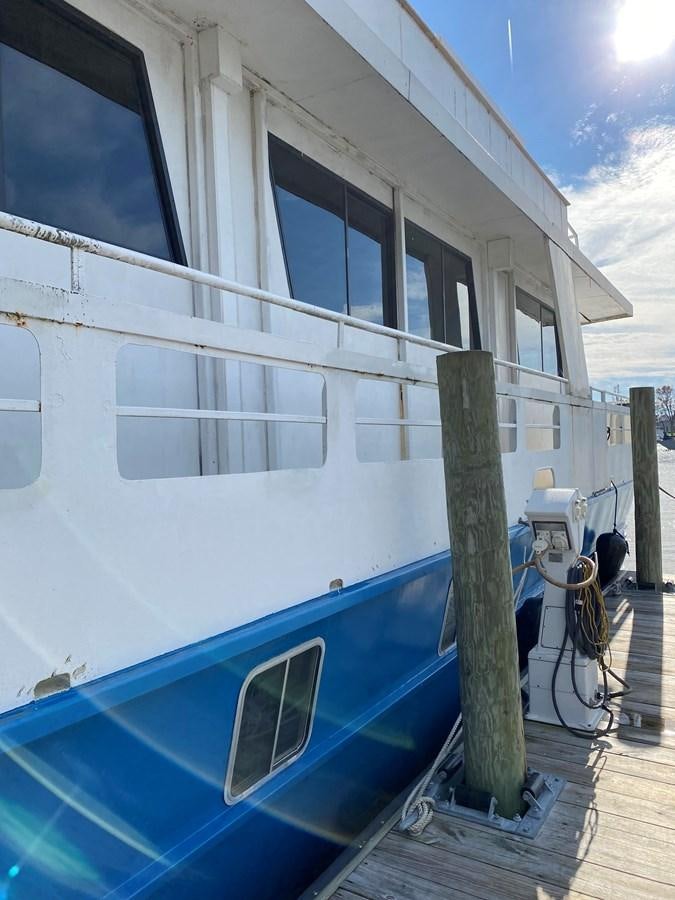 a white building with a blue pool aboard THE OASIS Yacht for Sale