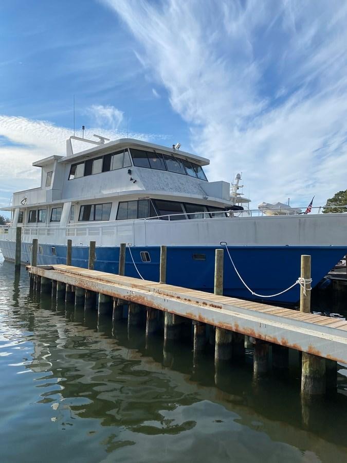 a boat docked at a pier aboard THE OASIS Yacht for Sale
