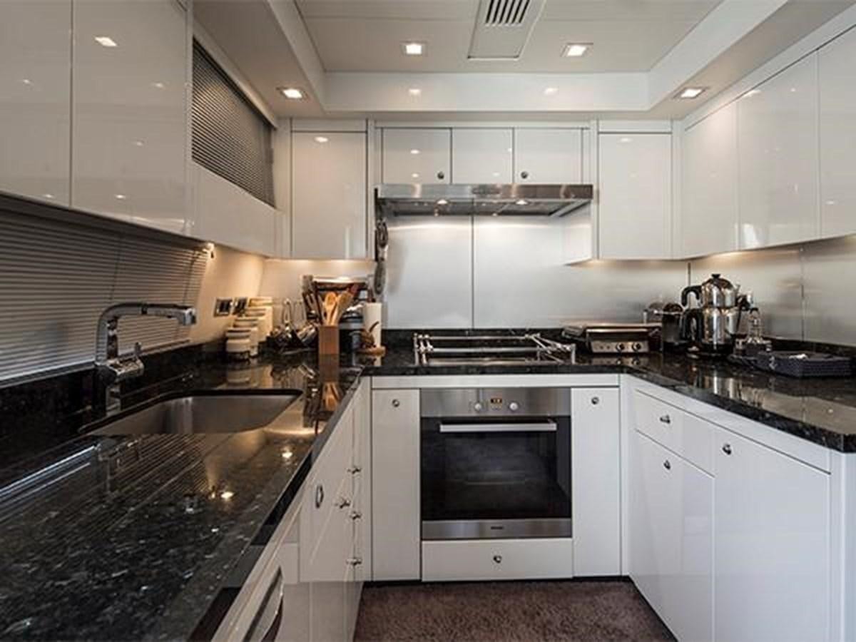 a kitchen with white cabinets aboard UNIQUE NAZ Yacht for Sale