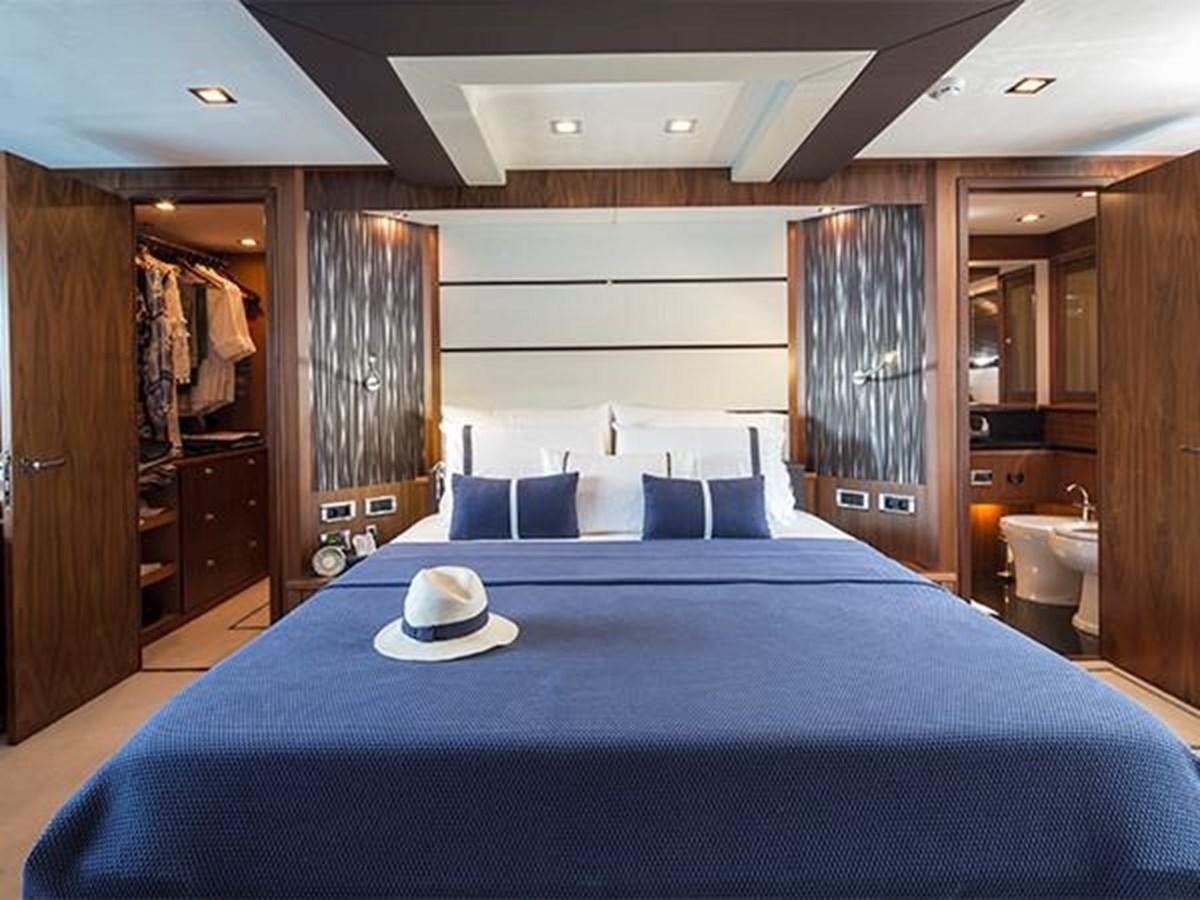 a bed with a blue sheet aboard UNIQUE NAZ Yacht for Sale