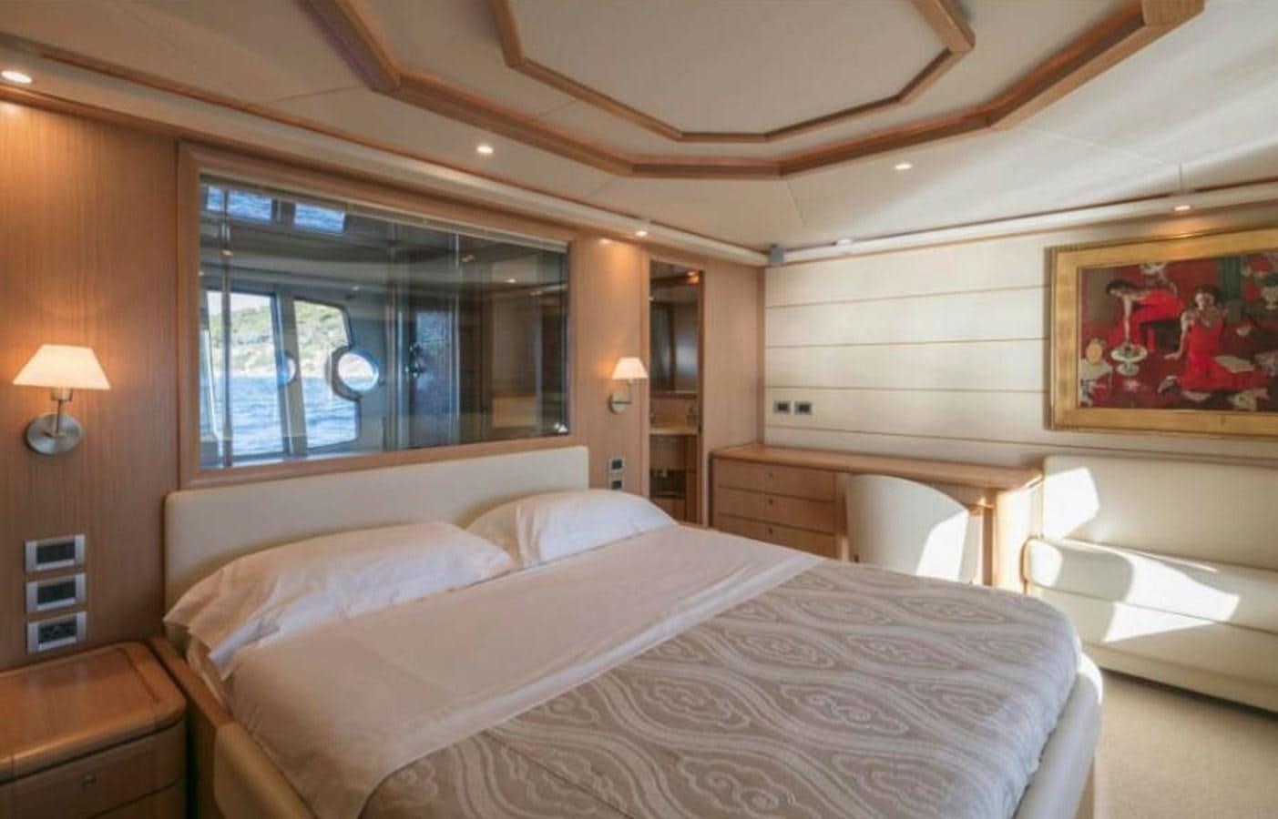 a bedroom with a bed and a window aboard FAIR LADY SILVIA Yacht for Sale