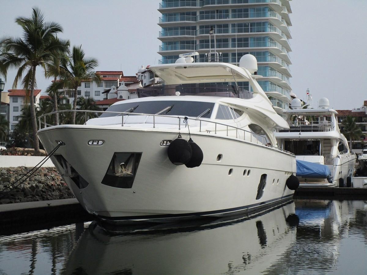 a white boat docked at a pier aboard NACL Yacht for Sale