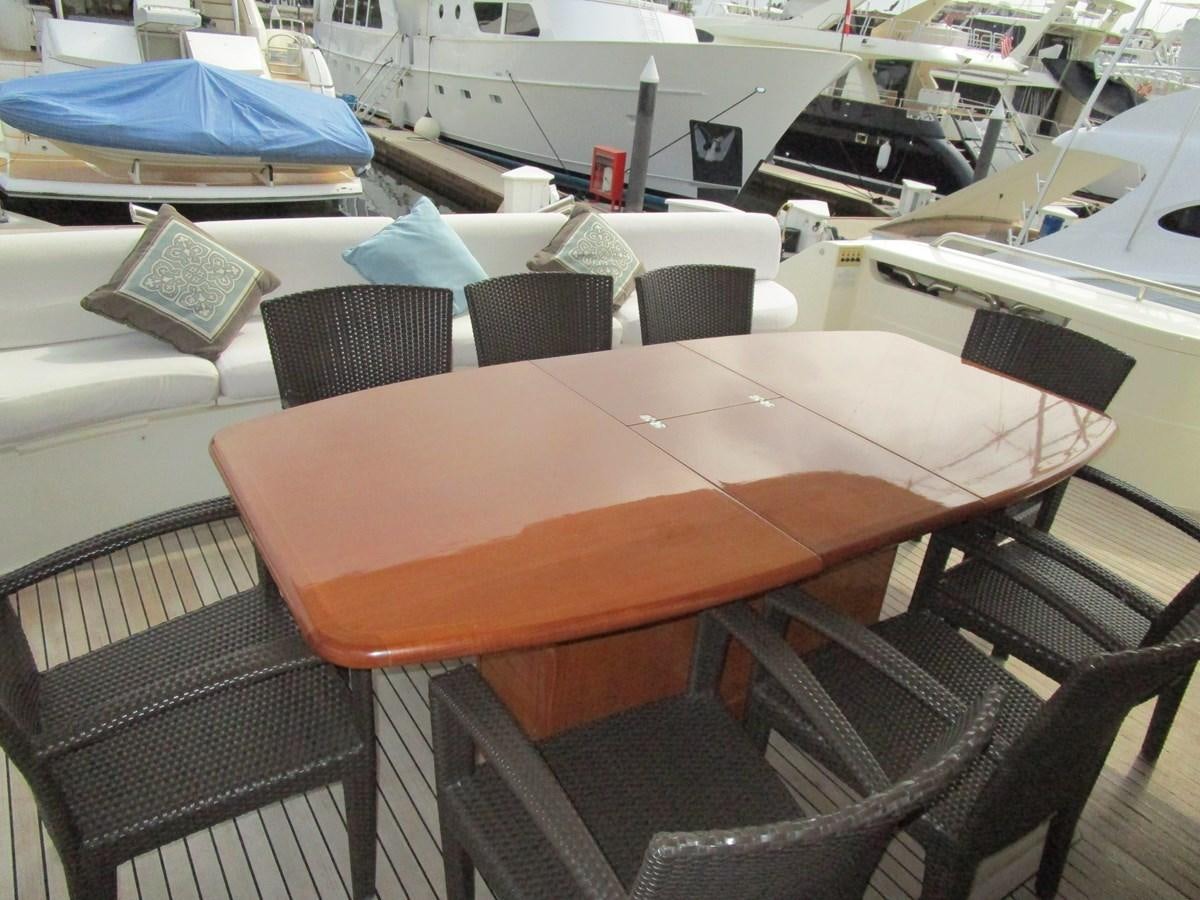 a table with chairs around it aboard NACL Yacht for Sale