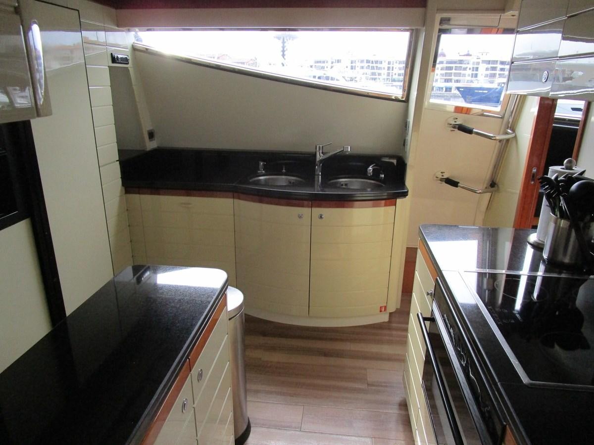 a kitchen with white cabinets aboard NACL Yacht for Sale