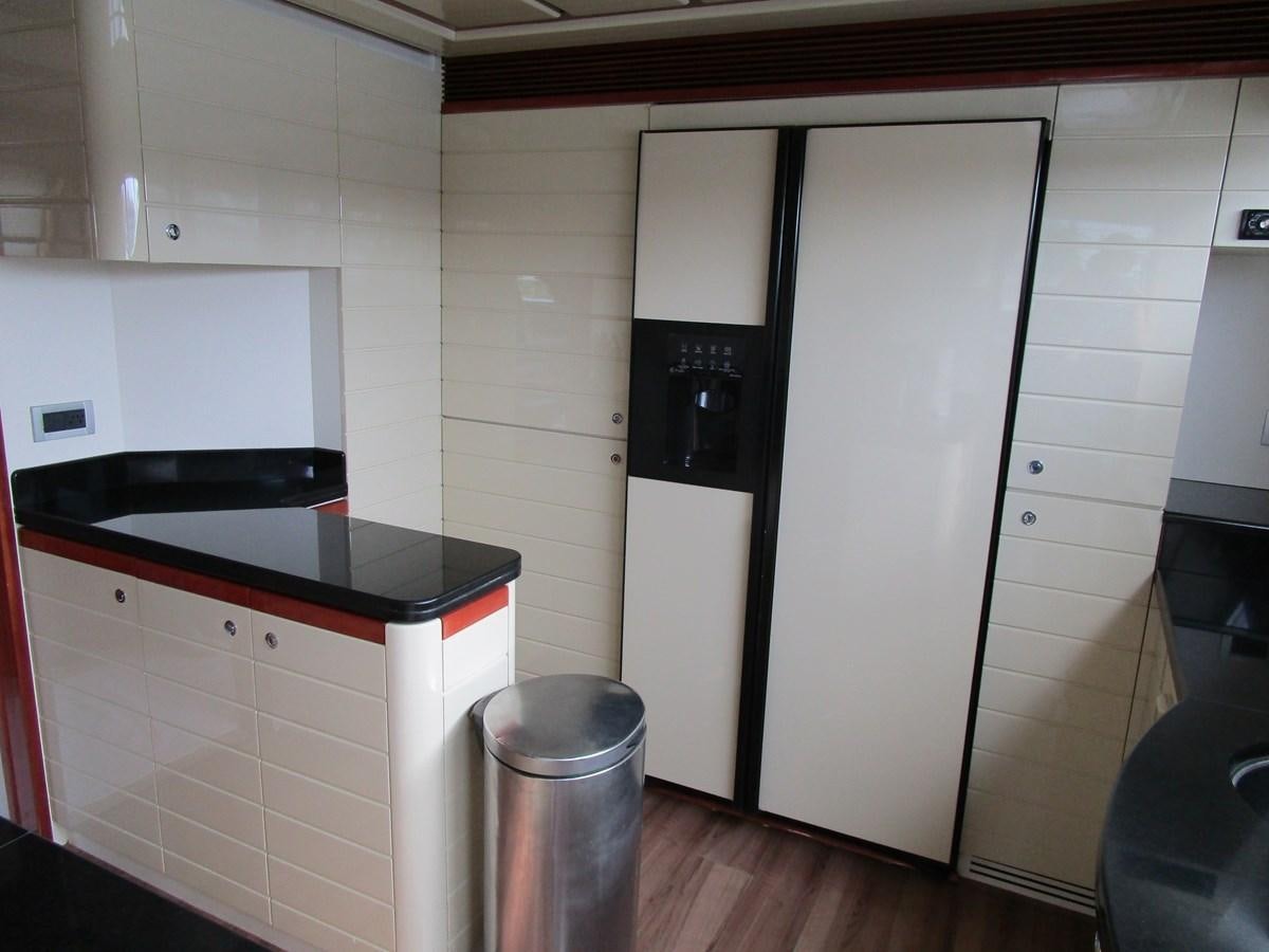 a kitchen with white cabinets aboard NACL Yacht for Sale