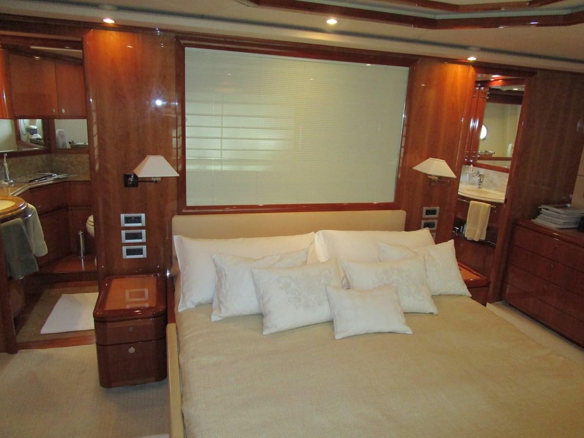 a bed with a white bed spread aboard NACL Yacht for Sale