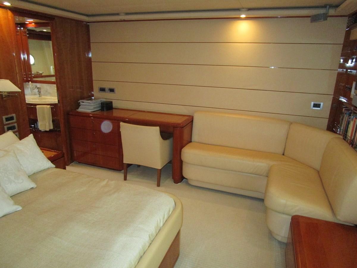 a room with a desk and couch aboard NACL Yacht for Sale