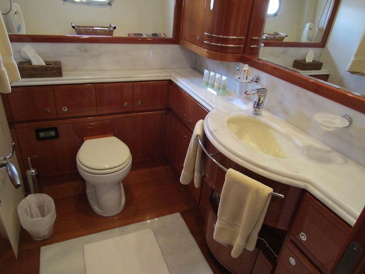 a bathroom with a sink toilet and a bathtub aboard NACL Yacht for Sale