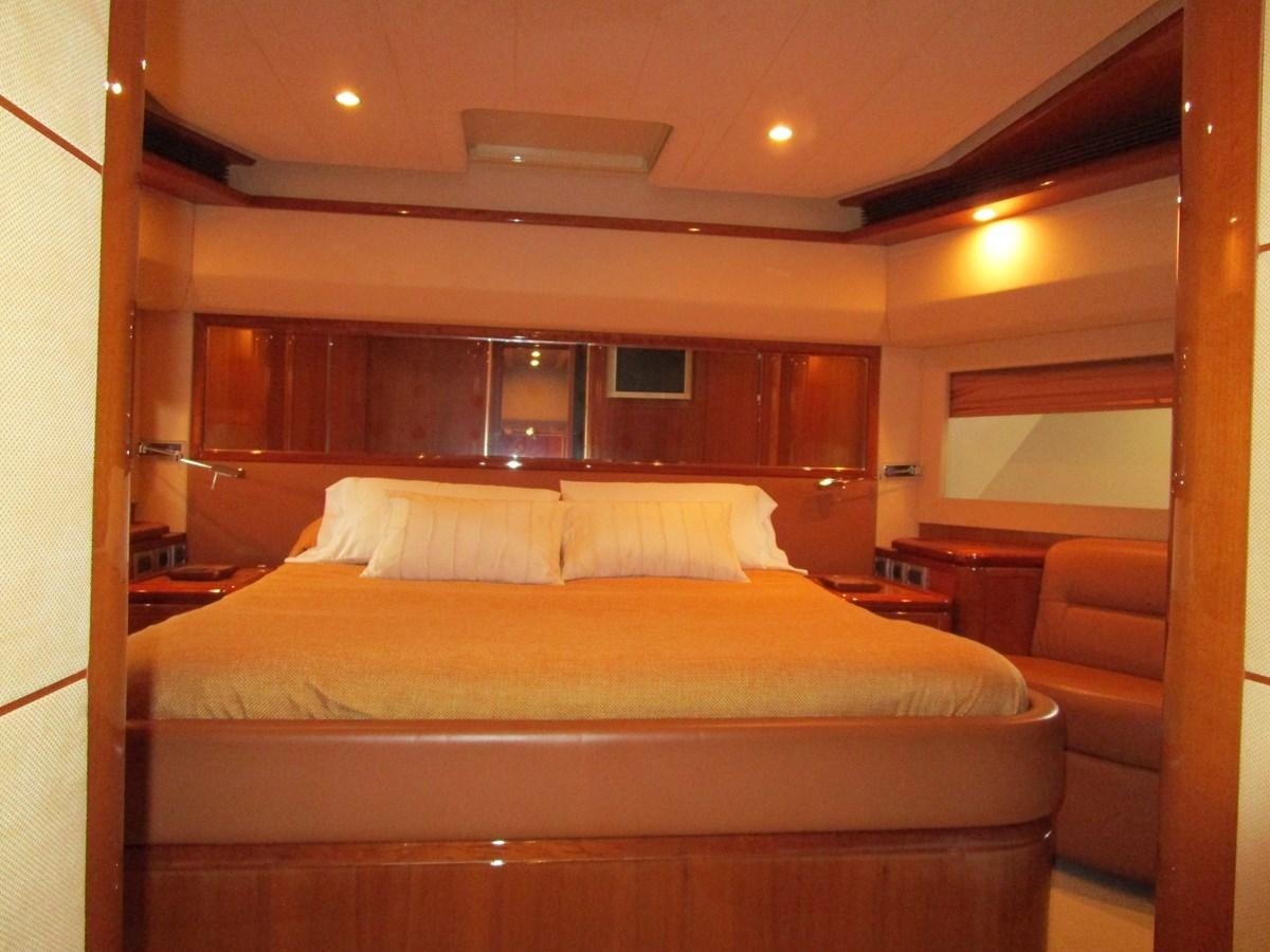 a bed with white sheets aboard NACL Yacht for Sale