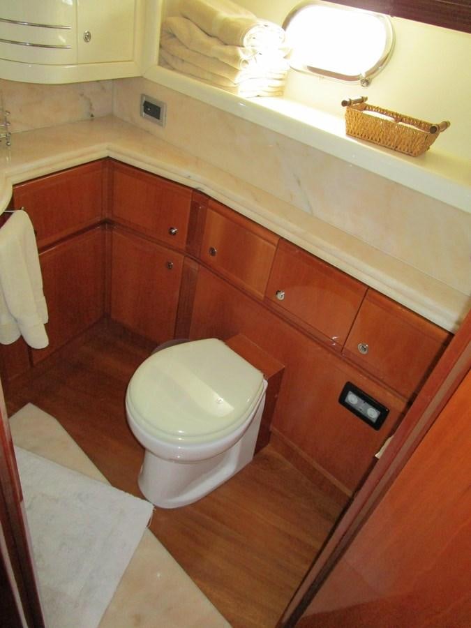 a bathroom with wooden cabinets aboard NACL Yacht for Sale