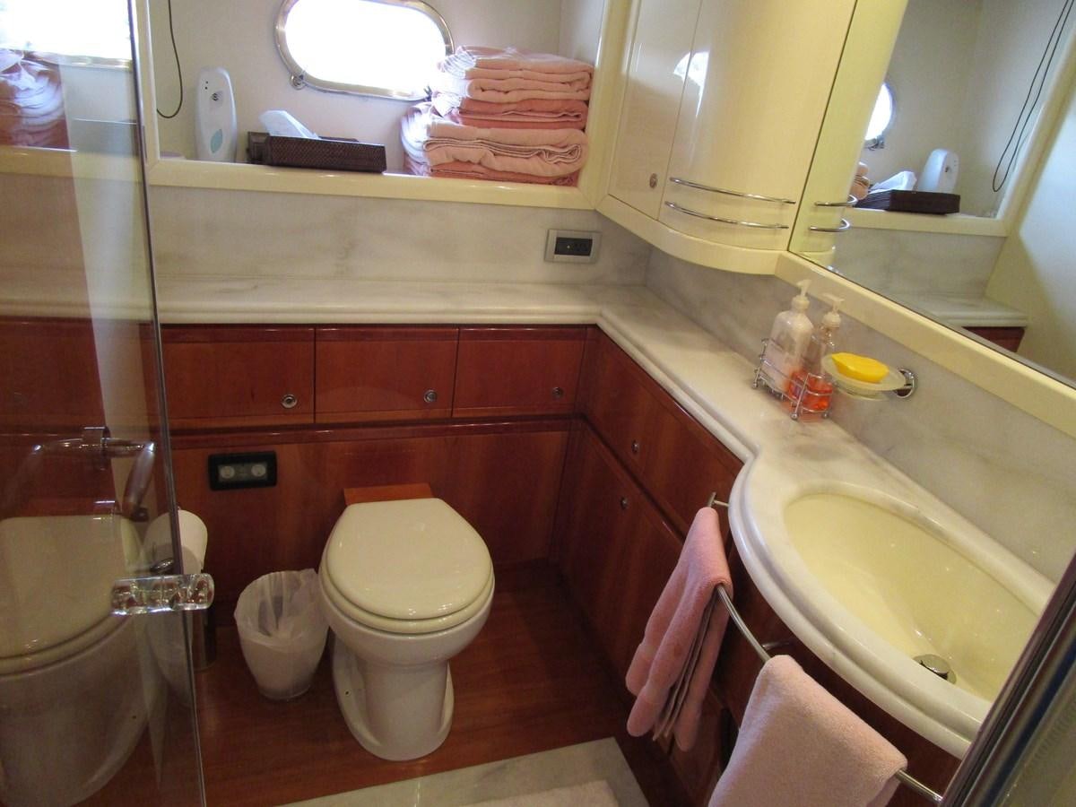a bathroom with a toilet and sink aboard NACL Yacht for Sale