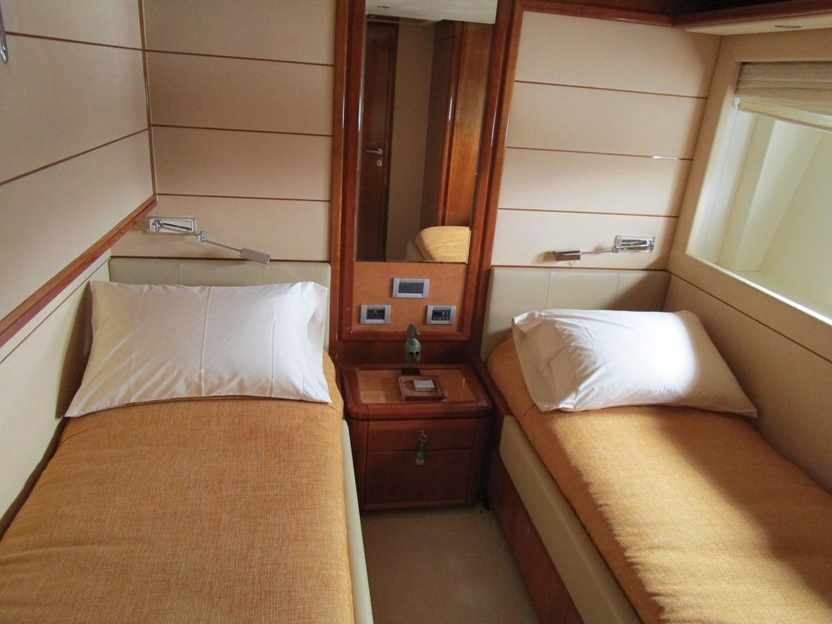 a room with a bed and a mirror aboard NACL Yacht for Sale