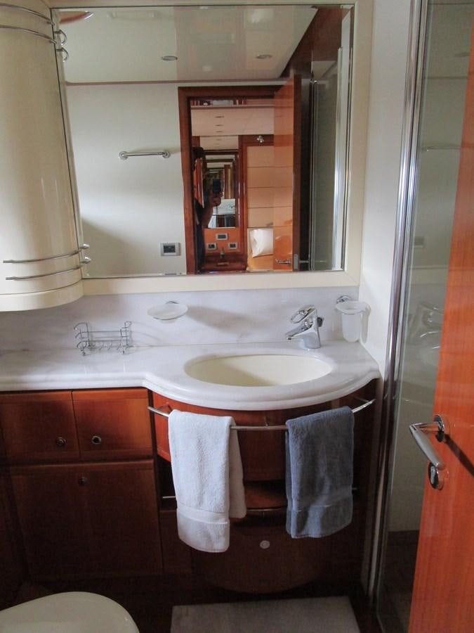 a bathroom with a sink and mirror aboard NACL Yacht for Sale