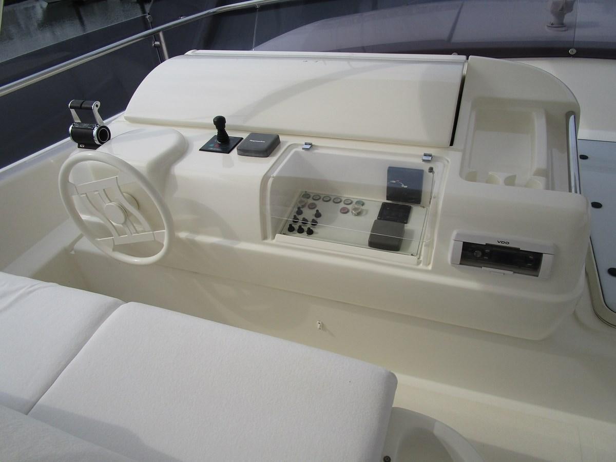 a white car with a white interior aboard NACL Yacht for Sale