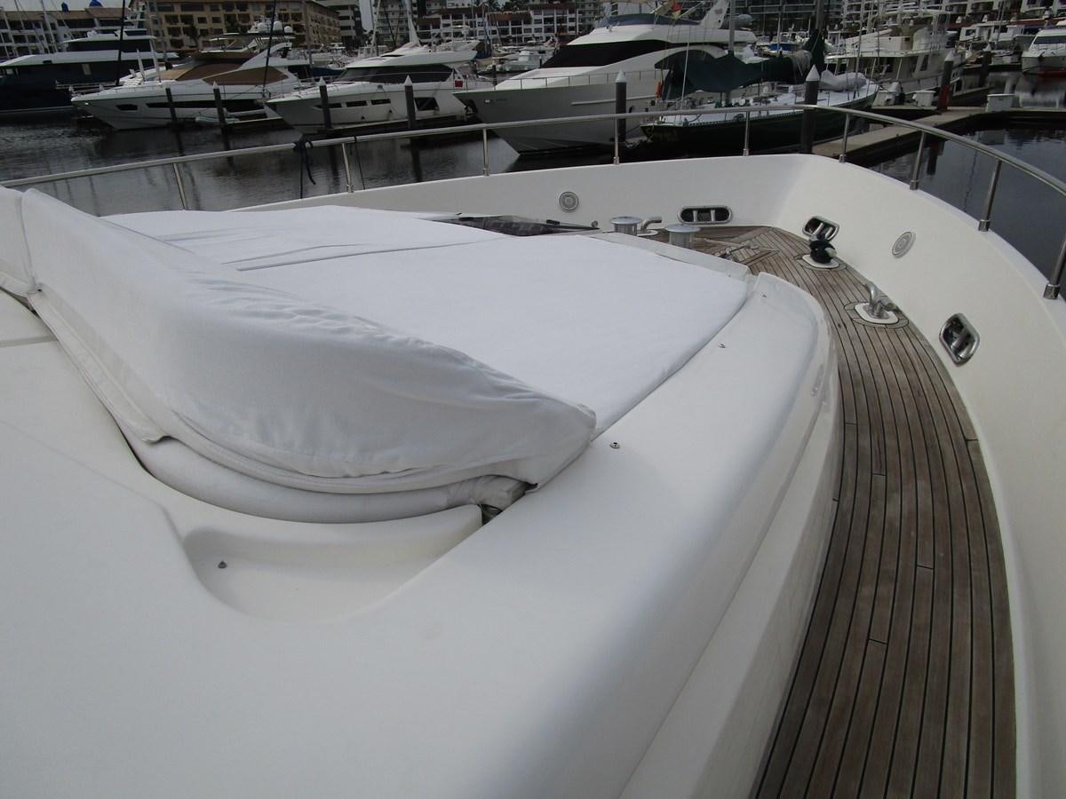 a large white boat in a harbor aboard NACL Yacht for Sale