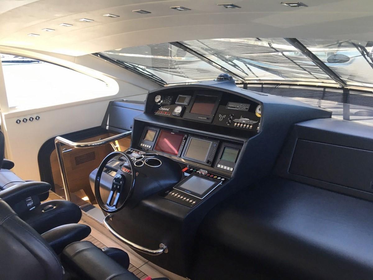 a car with a screen and headphones on the dashboard aboard MYSVEN Yacht for Sale