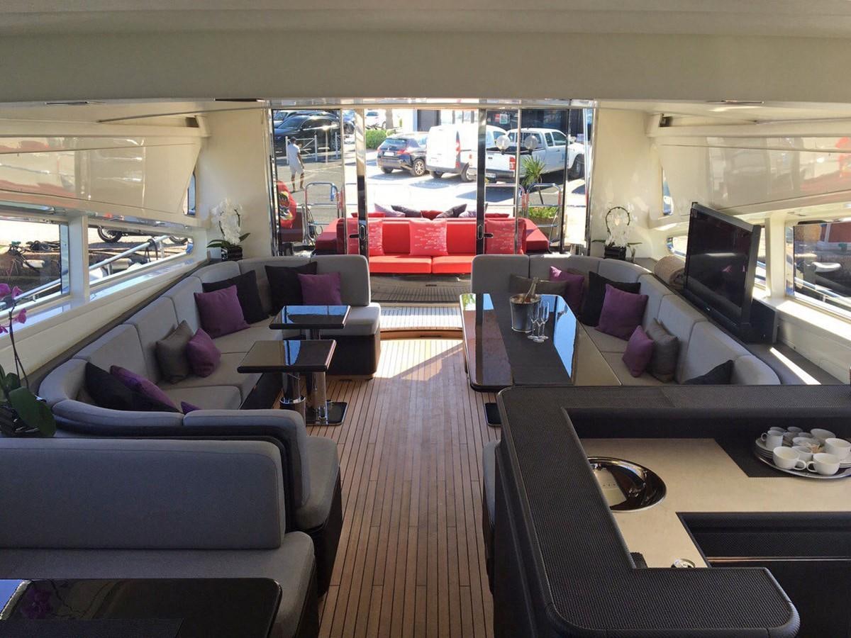 a room with a couch and a table with chairs and a window aboard MYSVEN Yacht for Sale