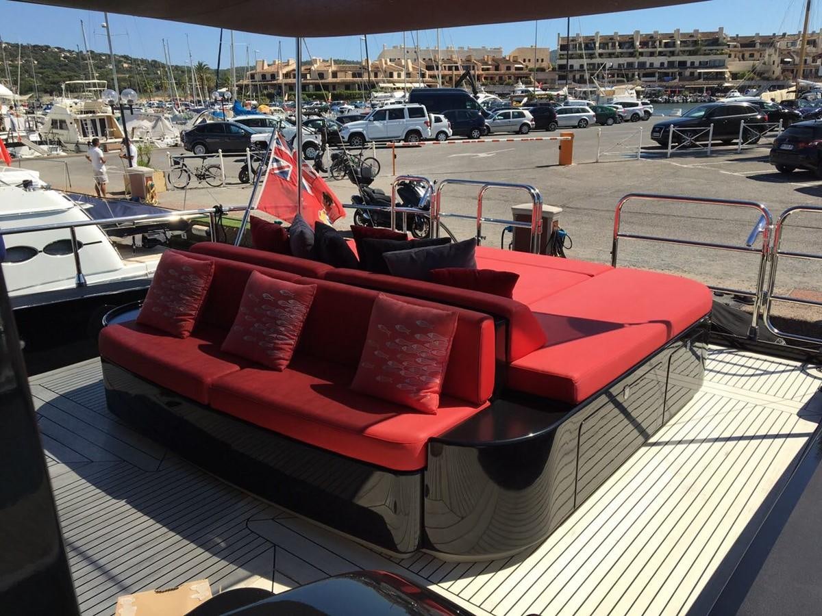 a red couch on a boat aboard MYSVEN Yacht for Sale